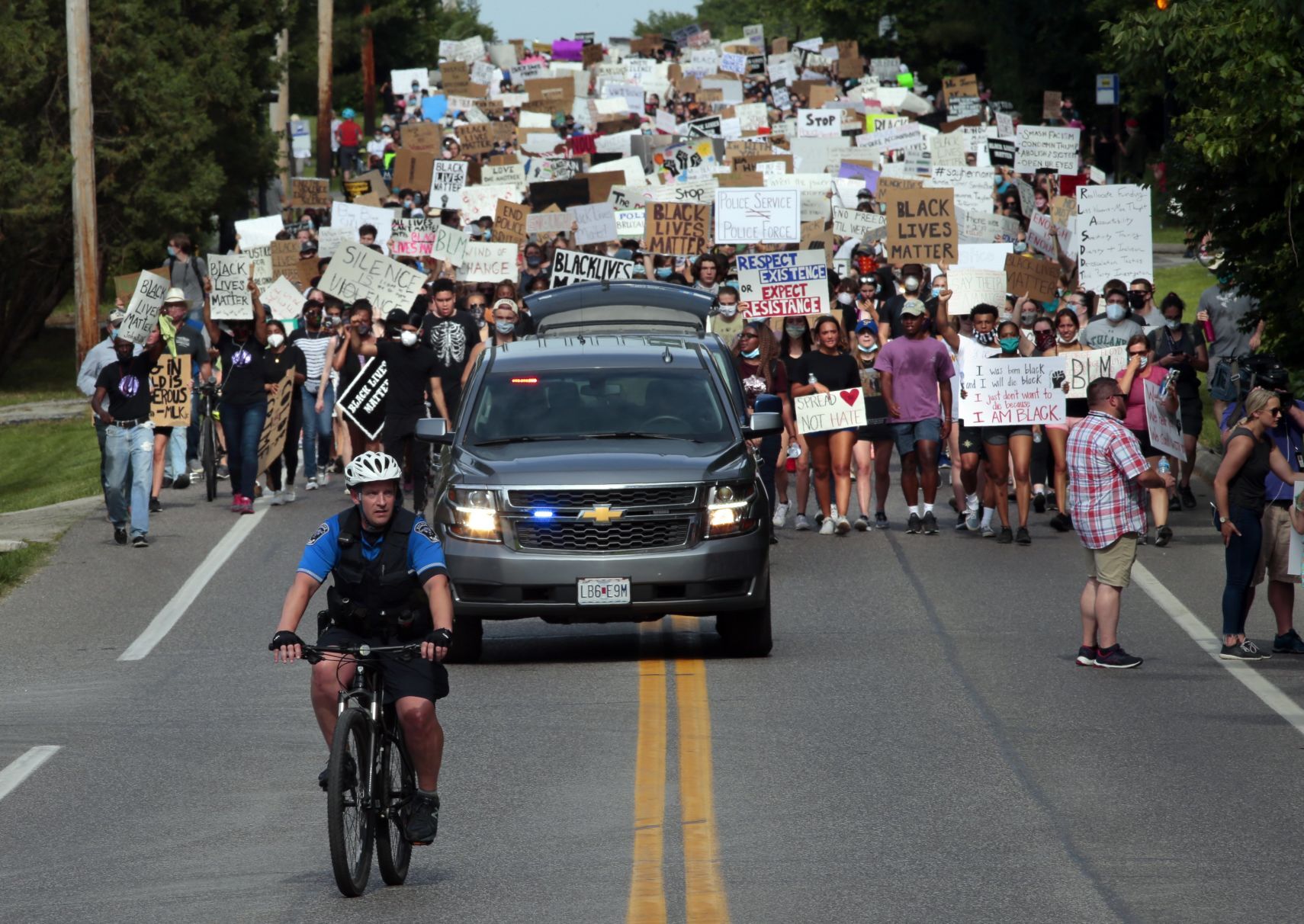 Youth march moves through wealthy suburbs